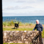 Man and his dog playing by the seaside