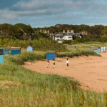 children playing on the beach by the sea