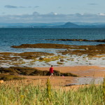 Child walking on the sandy beach