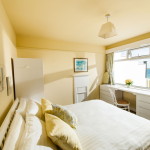 yellow bedroom with large window