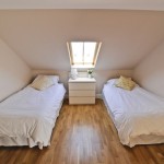 double bedroom with 2 white beds