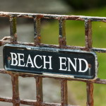 beach end sign on metal gate